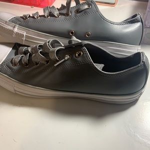 Grey leather converse with glitter laces.